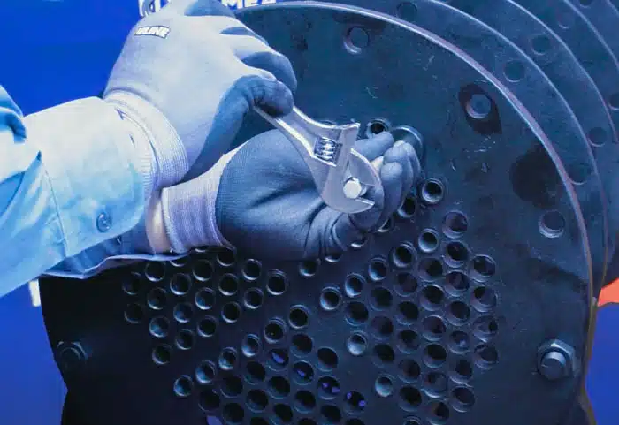 Using a wrench to turn and cut a heat exchanger tube with the One-Rev Internal Tube Cutter