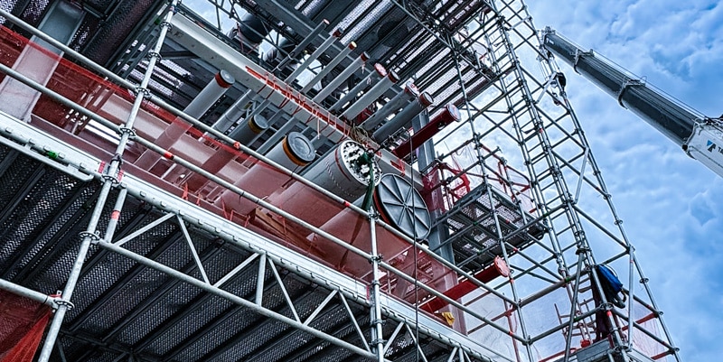 Scaffolding and heat exchanger installation at a pipe fabrication site
