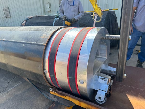 Custom rolling plug assembly being positioned into INVAR pipe during fabrication